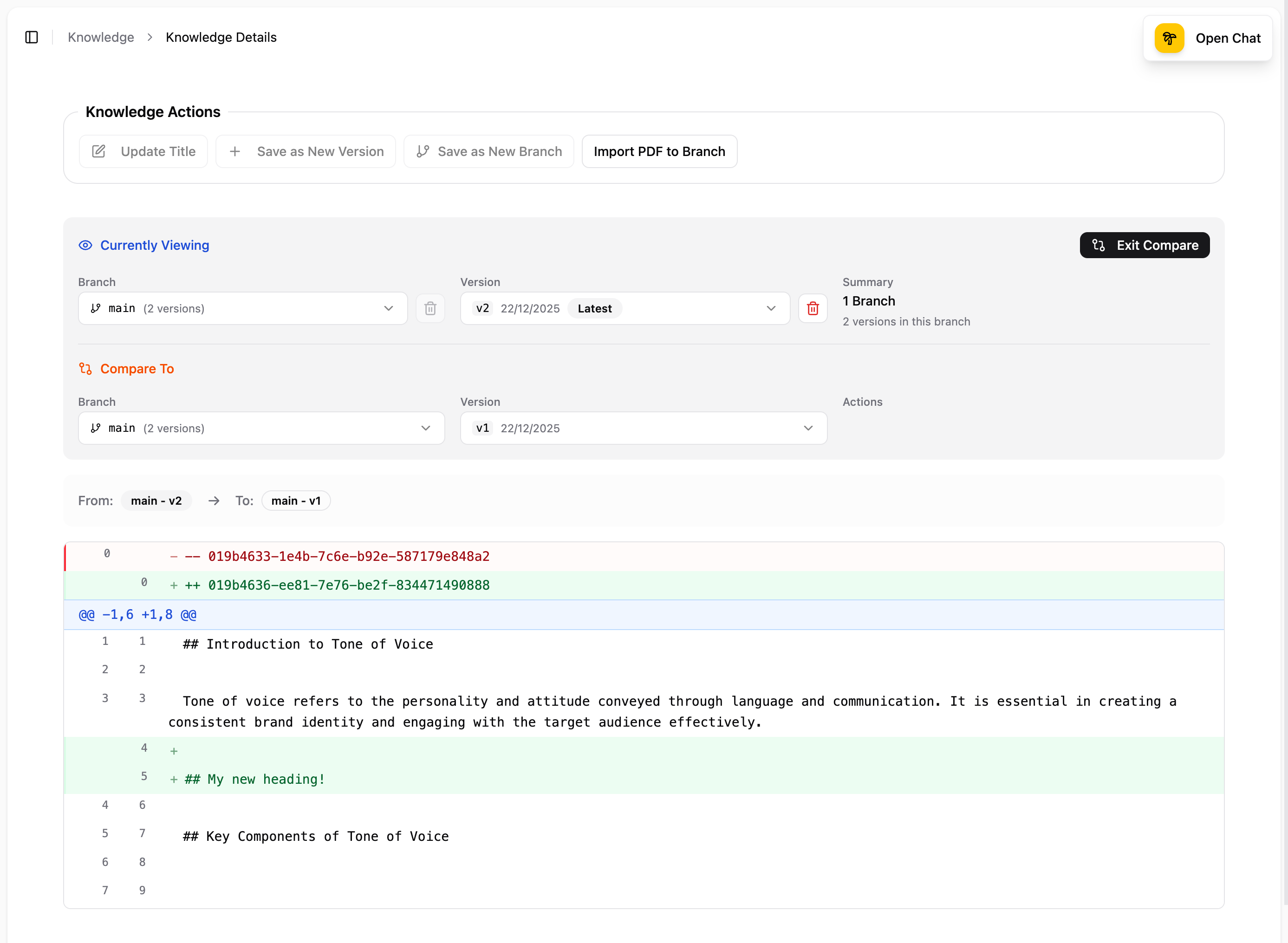 Diff viewer comparing two versions, showing the Currently Viewing version (main v2) and Compare To version (main v1) with line-by-line changes highlighted