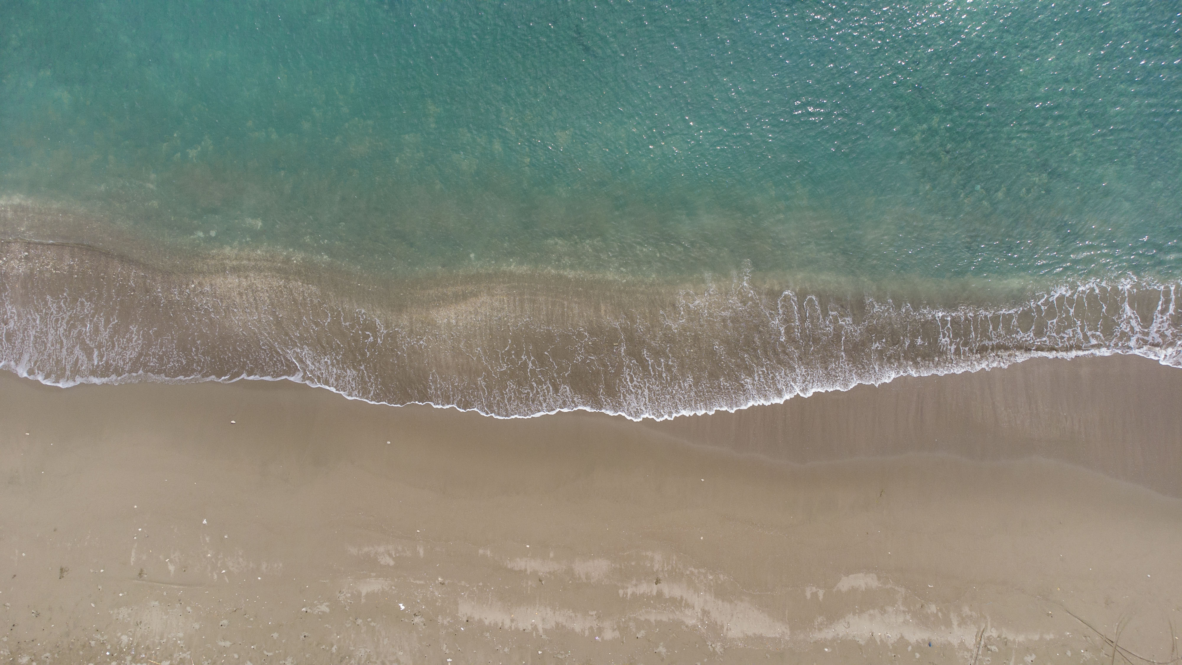 Aerial view of waves washing over a beach
